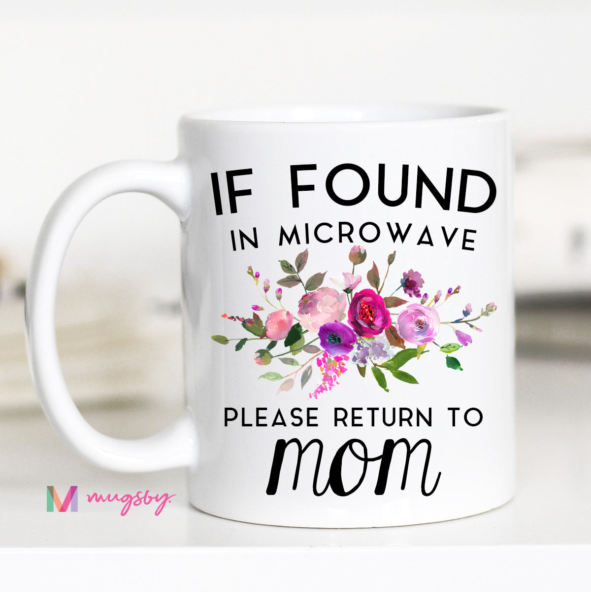 11 ounce white mug. Floral with text "if found in microwave please return to mom"