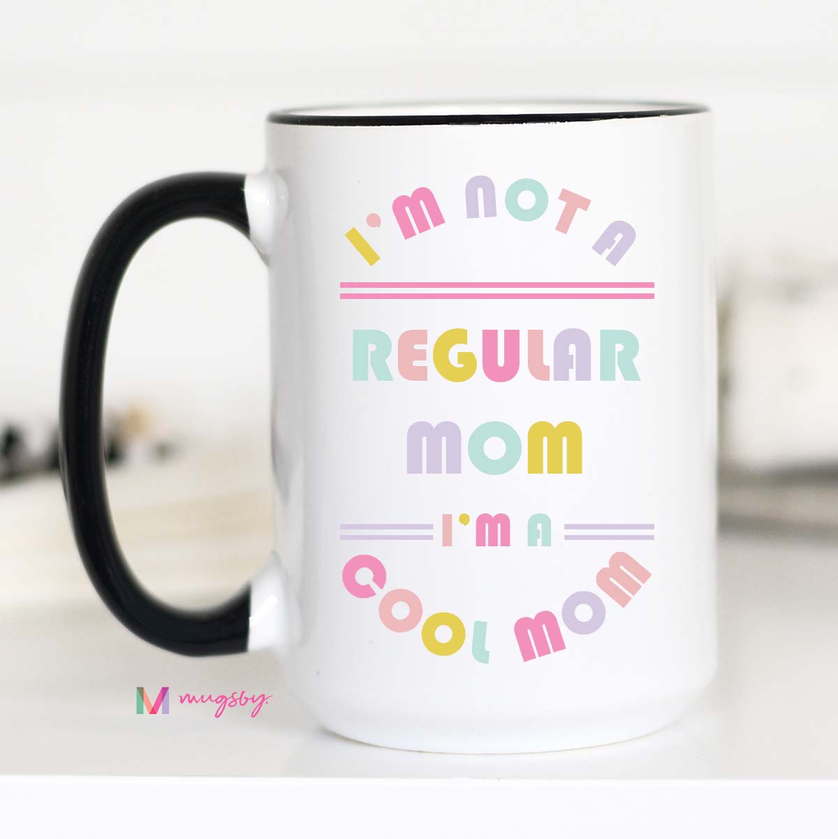 15 oz mug. Black handle and rim. "I'm not a regular mom I'm a cool mom"