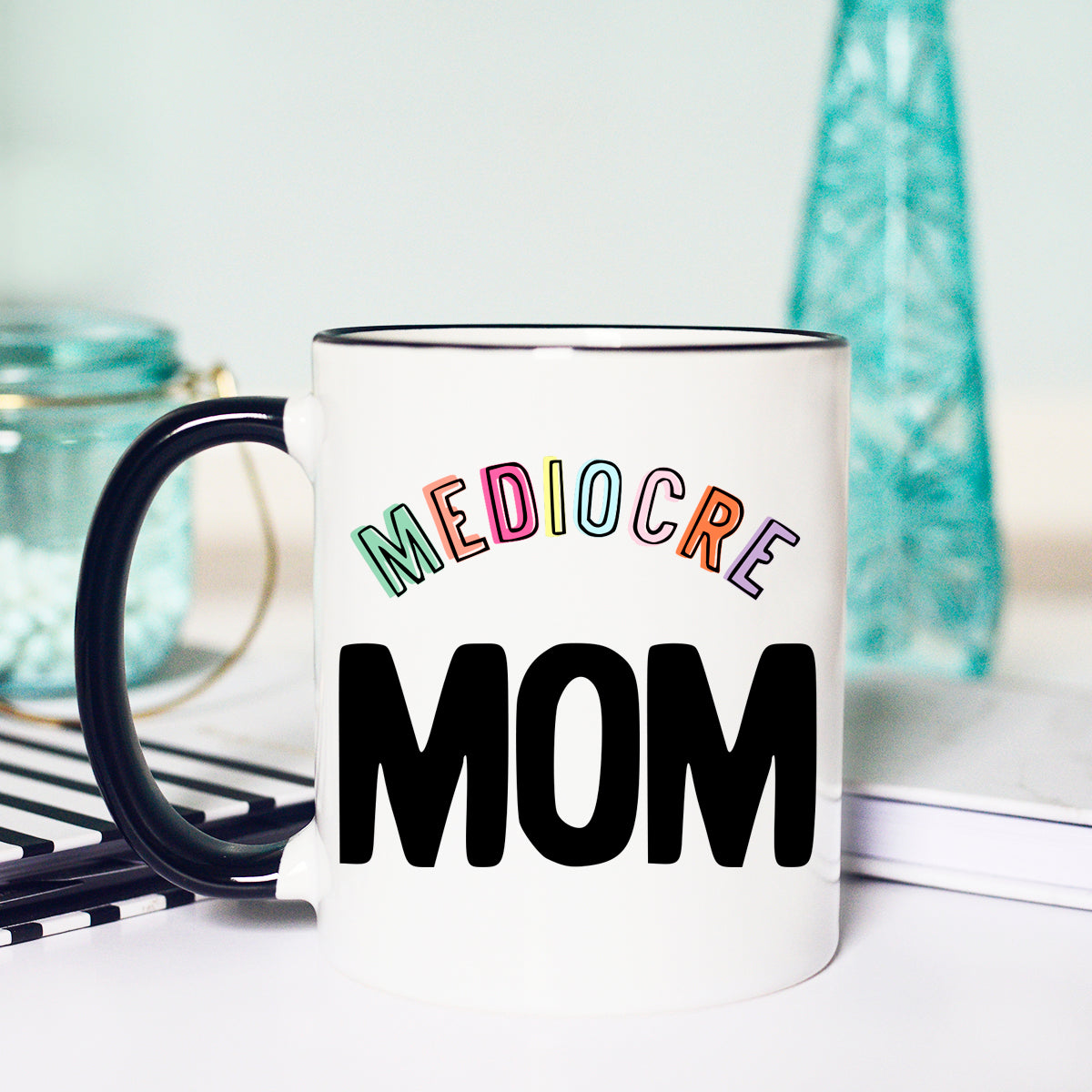 15 oz mug. Black handle and rim. "Mediocre MOM"