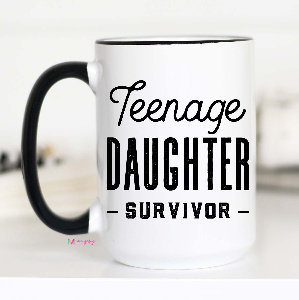 15 oz mug. Black handle and rim. "Teenage daughter survivor"